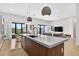 Open-concept kitchen featuring a large island with modern fixtures, seamless transition into the living area at 131 Forest Hills Dr, Redington Shores, FL 33708