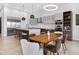 Modern kitchen with stainless steel appliances, island with seating, and adjacent dining area at 131 Forest Hills Dr, Redington Shores, FL 33708