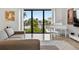 Bright living room featuring a modern piano with views of the water at 131 Forest Hills Dr, Redington Shores, FL 33708