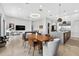Spacious open-concept living room with tile floors, modern lighting, and views into the kitchen at 131 Forest Hills Dr, Redington Shores, FL 33708