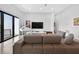 Living room featuring a comfortable sofa, sleek entertainment center, and access to the outside at 131 Forest Hills Dr, Redington Shores, FL 33708