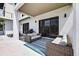 Outdoor patio with wicker furniture, grill and view of the backyard at 131 Forest Hills Dr, Redington Shores, FL 33708