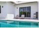 Relaxing poolside setting with lounge chairs and convenient grill at 131 Forest Hills Dr, Redington Shores, FL 33708