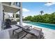 Inviting outdoor area with pool, spa, and comfortable lounge seating at 131 Forest Hills Dr, Redington Shores, FL 33708