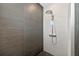Contemporary shower with dual shower heads and elegant tile work at 131 Forest Hills Dr, Redington Shores, FL 33708