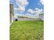 Green backyard with a white fence, and air conditioner at 13304 Mylion Way, Spring Hill, FL 34610