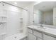 Bright bathroom with a single sink vanity and a tiled walk-in shower at 13304 Mylion Way, Spring Hill, FL 34610