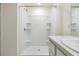 Clean bathroom featuring a walk-in shower with built in shelving and a sleek vanity at 13304 Mylion Way, Spring Hill, FL 34610