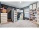 Well-lit bedroom with gray walls, white loft bed, and built-in shelving for ample storage and a modern feel at 13304 Mylion Way, Spring Hill, FL 34610