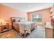 Cozy bedroom featuring a comfortable bed, natural light, and a charming bedside table at 13304 Mylion Way, Spring Hill, FL 34610