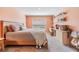 Comfortable bedroom with cozy bed, natural light, and a built-in desk for a workspace at 13304 Mylion Way, Spring Hill, FL 34610