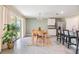 Bright dining area with bench seating, stylish rug, and access to the kitchen at 13304 Mylion Way, Spring Hill, FL 34610