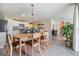 A kitchen and dining room area offers modern appliances, granite countertops, seating, and lots of natural light at 13304 Mylion Way, Spring Hill, FL 34610