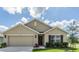 Charming single-story home features a two-car garage and well-maintained landscaping, perfect for curb appeal at 13304 Mylion Way, Spring Hill, FL 34610