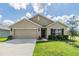 Charming single-story home features a two-car garage and well-maintained landscaping, perfect for curb appeal at 13304 Mylion Way, Spring Hill, FL 34610