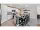 Modern kitchen boasts stainless appliances, granite countertops, and a central island with barstool seating at 13304 Mylion Way, Spring Hill, FL 34610