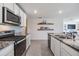 Bright kitchen features stainless steel appliances and granite countertops at 13304 Mylion Way, Spring Hill, FL 34610