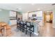 Bright kitchen boasts a spacious island with seating, granite countertops, and stainless-steel appliances at 13304 Mylion Way, Spring Hill, FL 34610