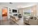 Inviting living room with modern fireplace, plush seating, and a neutral color palette at 13304 Mylion Way, Spring Hill, FL 34610