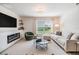 Living room features a fireplace, modern furniture, and large windows at 13304 Mylion Way, Spring Hill, FL 34610