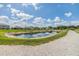 Scenic view of a tranquil pond with a walking path, offering a serene outdoor escape at 13304 Mylion Way, Spring Hill, FL 34610