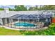 Aerial view showcases a beautiful screened-in pool and lush green backyard at 134 Barrington Dr, Brandon, FL 33511