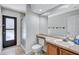 Bright bathroom featuring a glass-enclosed shower, wood vanity, and neutral countertops at 134 Barrington Dr, Brandon, FL 33511