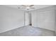 Neutral bedroom with plush carpet, ceiling fan, and closet with folding doors at 134 Barrington Dr, Brandon, FL 33511