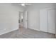 Bedroom with carpet, ceiling fan, closet, and an open door to other parts of the home at 134 Barrington Dr, Brandon, FL 33511