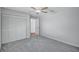 Comfortable bedroom with plush carpet, ceiling fan, and closet with folding doors at 134 Barrington Dr, Brandon, FL 33511
