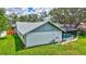 Back of the house featuring white stucco, grey roof, and screen enclosed pool at 134 Barrington Dr, Brandon, FL 33511