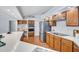 Bright kitchen with white counters, stainless steel appliances and warm wood cabinets and flooring at 134 Barrington Dr, Brandon, FL 33511