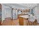 Bright open kitchen with stainless steel refrigerator, breakfast bar and wood cabinets at 134 Barrington Dr, Brandon, FL 33511