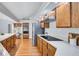 Bright kitchen with white counters, stainless steel appliances and warm wood cabinets at 134 Barrington Dr, Brandon, FL 33511