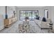 Stylish living room featuring neutral decor, plush carpeting, and views of the screened-in pool at 134 Barrington Dr, Brandon, FL 33511