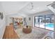 Open-concept living room with access to kitchen, screened lanai and outdoor pool at 134 Barrington Dr, Brandon, FL 33511
