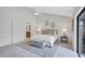Spacious main bedroom with ceiling fan, gray rug, and access to a luxurious ensuite at 134 Barrington Dr, Brandon, FL 33511