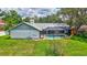 Back of the house view featuring the pool, and a large grassy yard at 134 Barrington Dr, Brandon, FL 33511