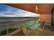A balcony with a table and chairs with ocean views and a colorful sunset at 1340 Gulf Blvd # 8C, Clearwater Beach, FL 33767