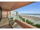 Balcony area featuring outdoor furniture with expansive beach and ocean views, and beachfront condos at 1340 Gulf Blvd # 8C, Clearwater Beach, FL 33767