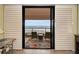 Ocean view from the balcony with seating area that includes two chairs and a table at 1340 Gulf Blvd # 8C, Clearwater Beach, FL 33767