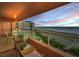 Outdoor balcony with views of the beach, ocean and a sunset sky with dining table and chairs at 1340 Gulf Blvd # 8C, Clearwater Beach, FL 33767