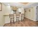 Basement bar with seating and views into the kitchen and dining area at 1340 Gulf Blvd # 8C, Clearwater Beach, FL 33767