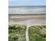 Beautiful beach view showing sand dunes, a walkway to the beach and the ocean at 1340 Gulf Blvd # 8C, Clearwater Beach, FL 33767