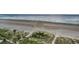 Aerial beach view showing path to the beach and lush vegetation at 1340 Gulf Blvd # 8C, Clearwater Beach, FL 33767