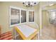 Bright dining area with a table and chairs by the windows, adjacent to a kitchen at 1340 Gulf Blvd # 8C, Clearwater Beach, FL 33767