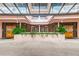 Elegant entrance with a covered walkway and symmetrical wood doors flanked by planters at 1340 Gulf Blvd # 8C, Clearwater Beach, FL 33767