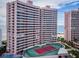Exterior shot of a high-rise condo building with many floors next to the tennis court at 1340 Gulf Blvd # 8C, Clearwater Beach, FL 33767