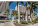 Building exterior with lush landscaping, including palms, offering a private and secure entrance for the residents at 1340 Gulf Blvd # 8C, Clearwater Beach, FL 33767