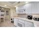Kitchen with white appliances and cabinets, adjacent to the breakfast nook for convenient dining at 1340 Gulf Blvd # 8C, Clearwater Beach, FL 33767